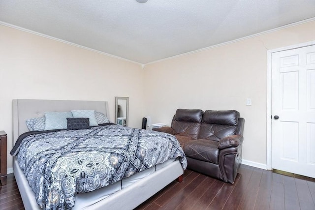 bedroom with baseboards, ornamental molding, and wood finished floors