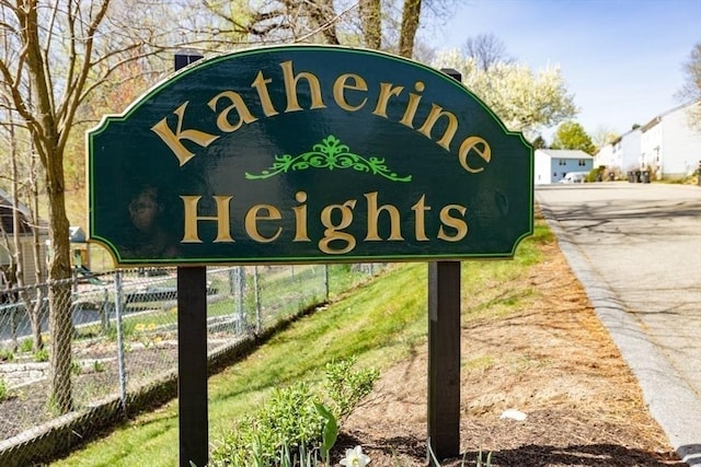 community sign featuring fence