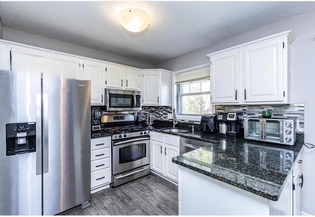 kitchen featuring white cabinets, appliances with stainless steel finishes, a sink, and a toaster