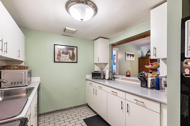 96 Old Colony Ave Unit 153, Taunton, MA 02718 - kitchen with white microwave, light countertops, white cabinets, and stove