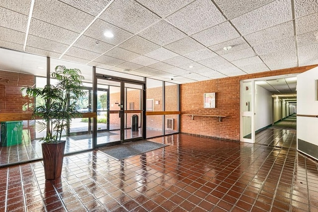 96 Old Colony Ave Unit 153, Taunton, MA 02718 - common area featuring brick wall and a paneled ceiling