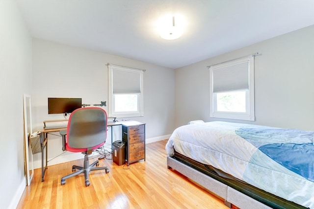 49 Hopkins Dr, Whitman, MA 02382 - bedroom with multiple windows, light wood-type flooring, baseboards, and an office area