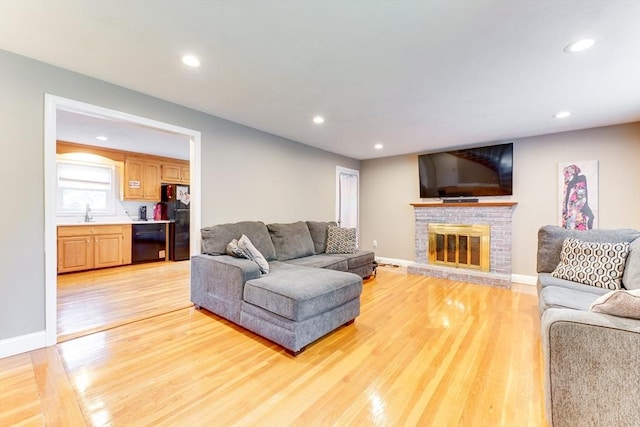 49 Hopkins Dr, Whitman, MA 02382 - living area with light wood-type flooring, a fireplace, recessed lighting, and baseboards