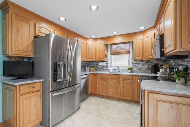 kitchen with recessed lighting, stainless steel appliances, a sink, decorative backsplash, and light countertops