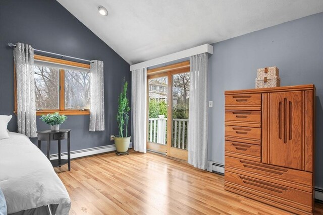 bedroom featuring lofted ceiling, access to outside, light wood-style flooring, and a baseboard heating unit