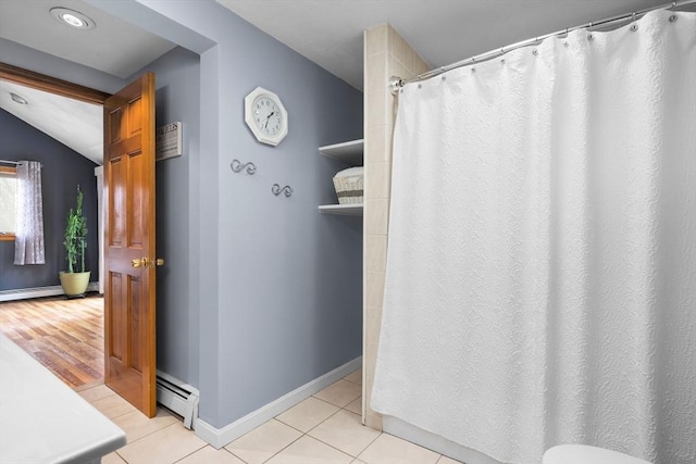 bathroom featuring a shower with shower curtain, tile patterned flooring, baseboards, and a baseboard heating unit