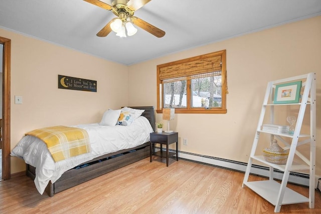 bedroom featuring a baseboard radiator and wood finished floors