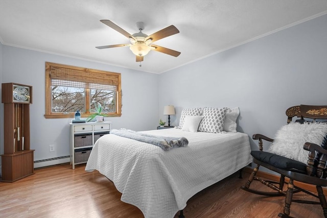 bedroom featuring a baseboard radiator, ornamental molding, and wood finished floors