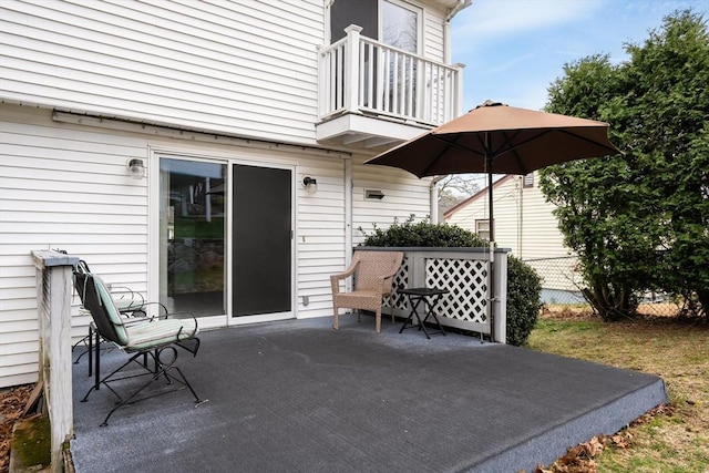 view of patio / terrace featuring a balcony and fence
