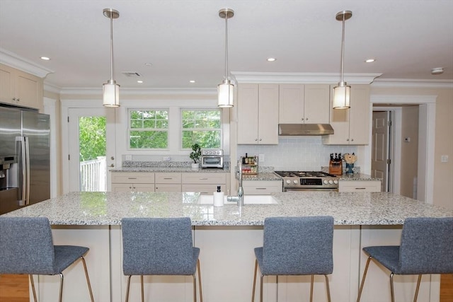 kitchen featuring a spacious island, appliances with stainless steel finishes, and decorative light fixtures