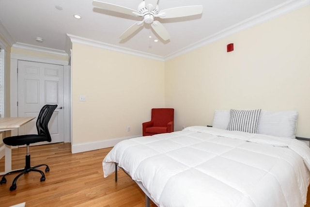 bedroom with hardwood / wood-style flooring, ceiling fan, and crown molding