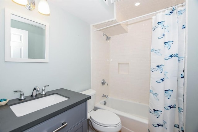 full bathroom with vanity, shower / tub combo with curtain, and toilet