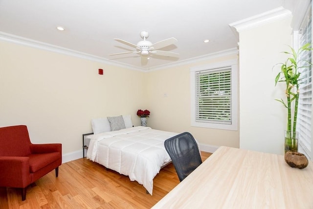 bedroom featuring hardwood / wood-style flooring, ceiling fan, and crown molding