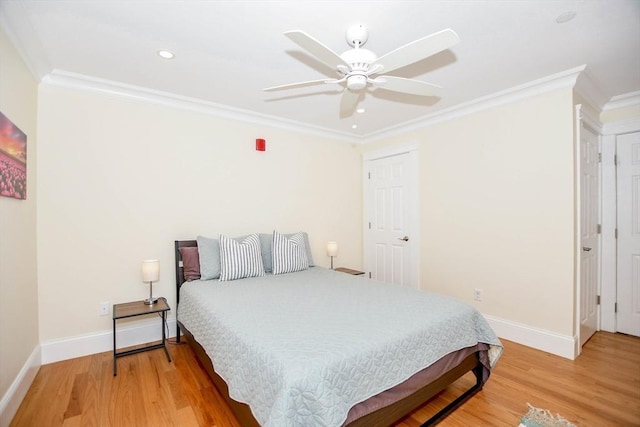 bedroom featuring ornamental molding, wood-type flooring, and ceiling fan