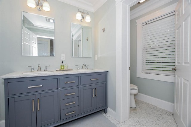 bathroom with crown molding, vanity, and toilet