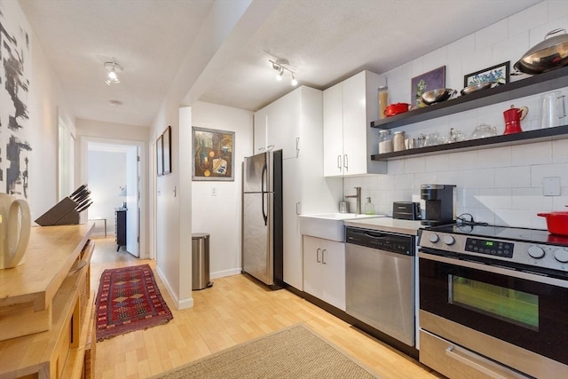 800 Bearses Way Unit 5Ec, Barnstable, MA 02601 - kitchen with stainless steel appliances, light wood-style flooring, white cabinets, and backsplash