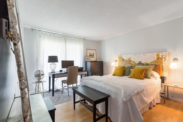 800 Bearses Way Unit 5Ec, Barnstable, MA 02601 - bedroom featuring wood finished floors, baseboard heating, and an office area