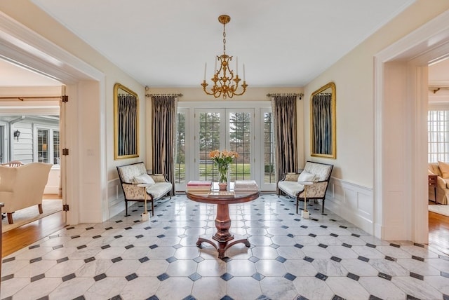 sitting room with light hardwood / wood-style floors and a chandelier