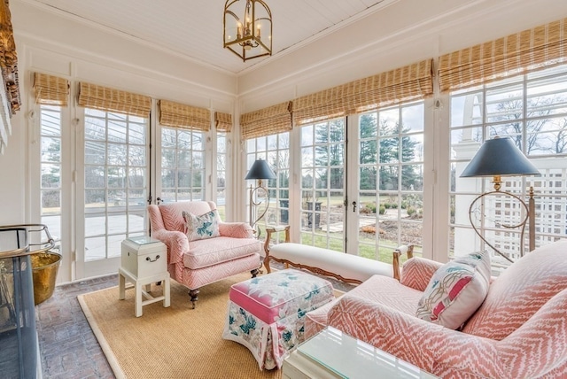 sunroom / solarium with an inviting chandelier and a healthy amount of sunlight