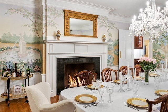 living area featuring a chandelier, hardwood / wood-style flooring, and ornamental molding