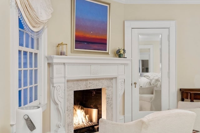 interior space featuring a high end fireplace and ornamental molding