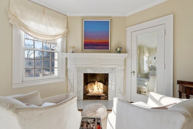 living room with a high end fireplace and crown molding