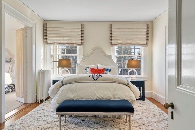 bedroom featuring light wood-type flooring and radiator