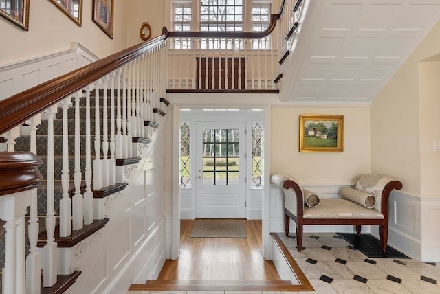 foyer entrance with a high ceiling and light wood-type flooring