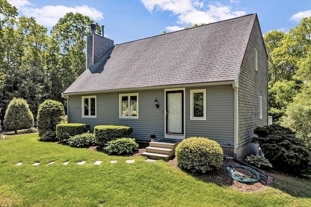 17 Claus, Barnstable, MA 02648 - view of front of house with a chimney, a front lawn, and roof with shingles