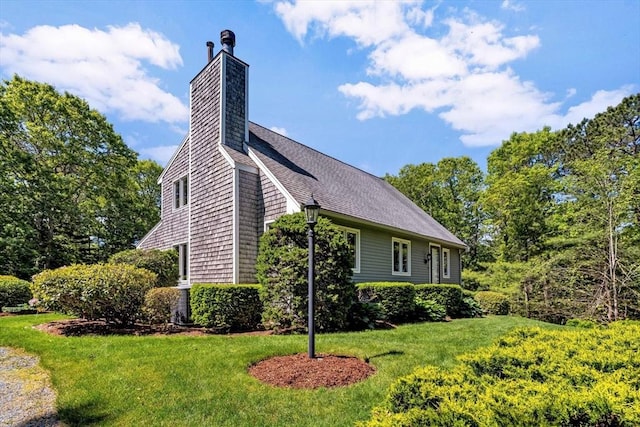 17 Claus, Barnstable, MA 02648 - view of side of property featuring a lawn, a chimney, and roof with shingles
