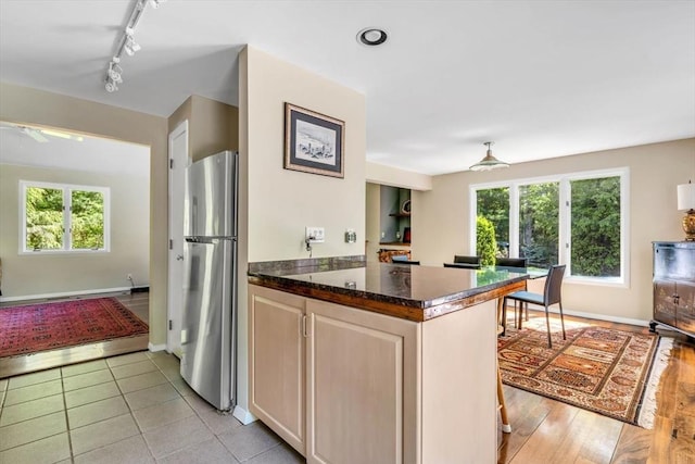 17 Claus, Barnstable, MA 02648 - kitchen featuring freestanding refrigerator, track lighting, plenty of natural light, and dark stone counters