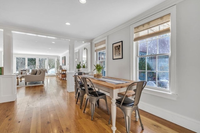 dining space featuring recessed lighting, baseboards, ornamental molding, and light wood finished floors