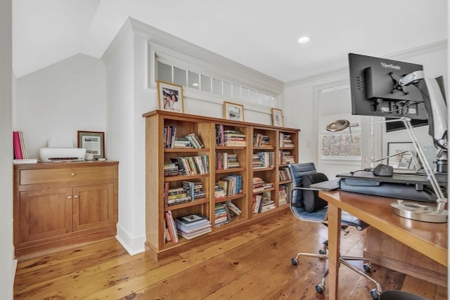 home office featuring crown molding, light wood-type flooring, and lofted ceiling