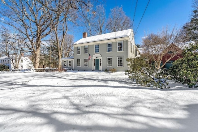 colonial inspired home with a chimney