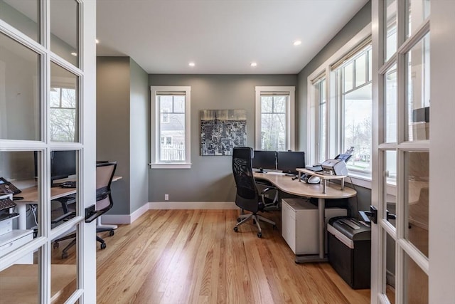 office space featuring recessed lighting, baseboards, and light wood finished floors