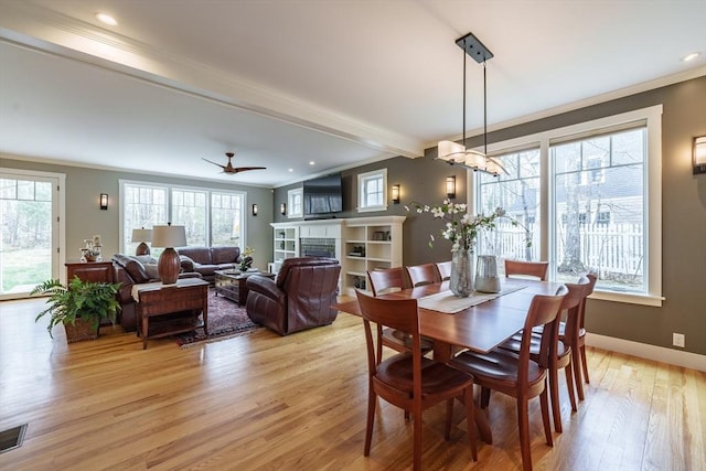 dining room with light wood-style floors, ornamental molding, baseboards, and recessed lighting