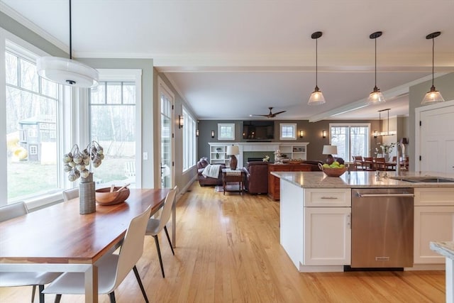 kitchen with white cabinets, crown molding, light wood-style flooring, and dishwasher