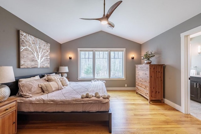 bedroom featuring connected bathroom, ceiling fan, visible vents, light wood-type flooring, and vaulted ceiling