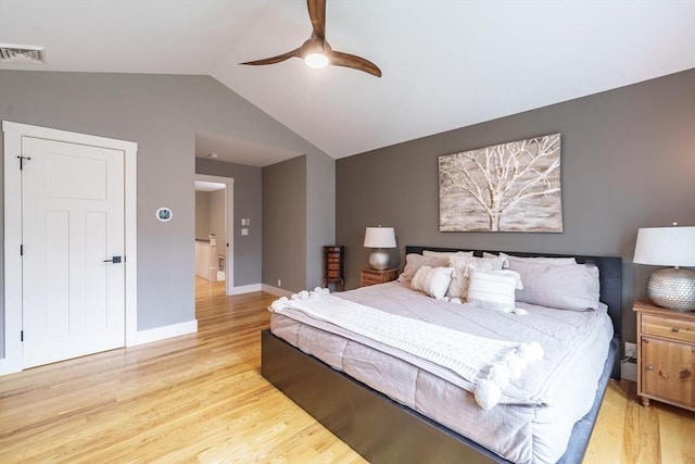 bedroom with baseboards, visible vents, vaulted ceiling, and light wood-type flooring