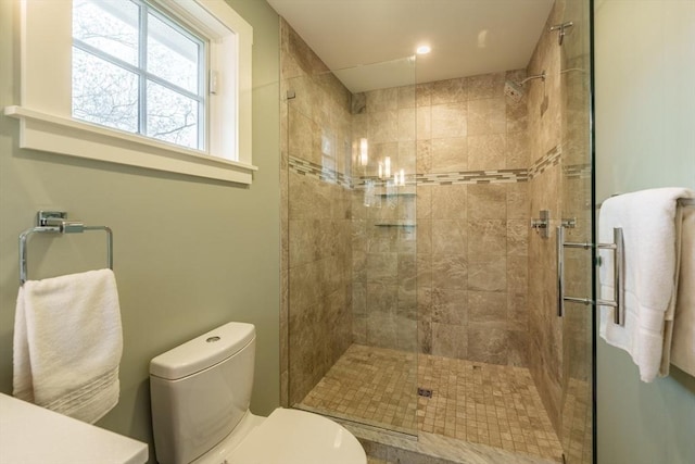 bathroom featuring toilet and tiled shower