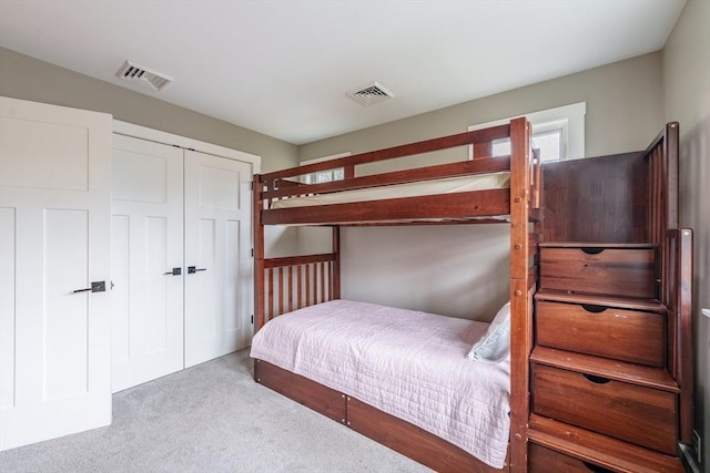 bedroom with a closet, carpet flooring, and visible vents