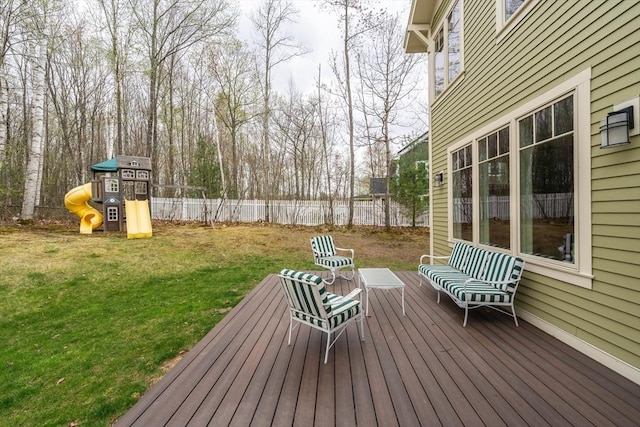 wooden terrace with a playground, fence, and a yard