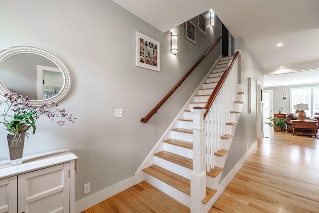staircase with baseboards, recessed lighting, wood finished floors, and visible vents