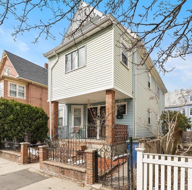 view of front of home featuring a porch, a gate, and a fenced front yard