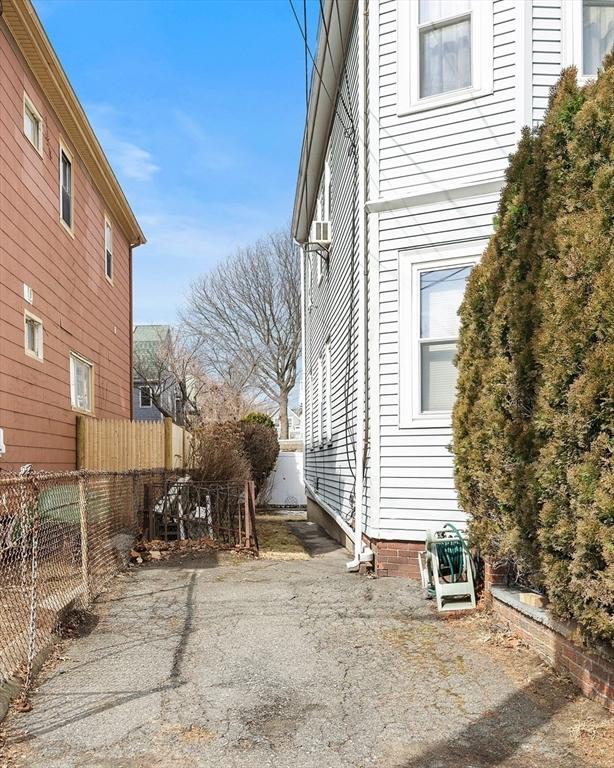 view of side of home featuring fence