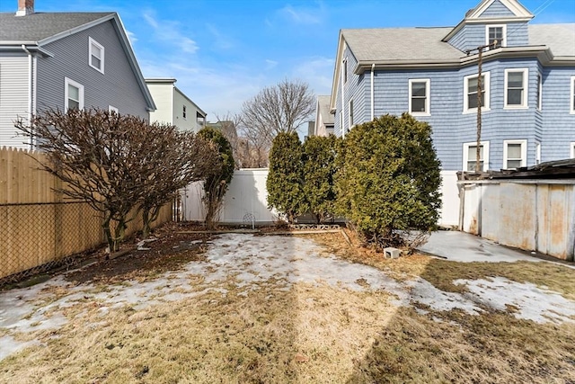 view of side of home featuring a fenced backyard