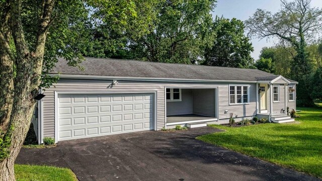 11 Rose Ave, Westport, MA 02790 - single story home with asphalt driveway, an attached garage, and a front lawn