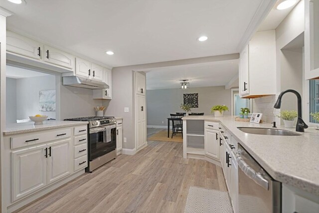 11 Rose Ave, Westport, MA 02790 - kitchen with appliances with stainless steel finishes, under cabinet range hood, light wood-style floors, white cabinets, and recessed lighting