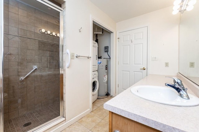 bathroom with an enclosed shower, vanity, water heater, tile patterned flooring, and stacked washer and dryer