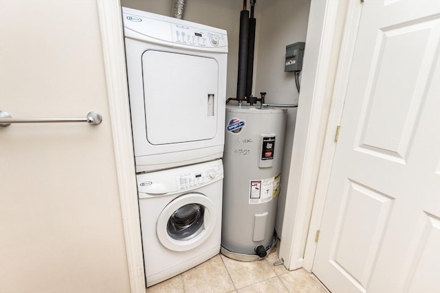 washroom with light tile patterned floors, electric water heater, and stacked washer / drying machine